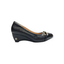MOODBOARD black leather wedge pump with a gold-tone metal chain detail on the toe and a small logo on the heel.